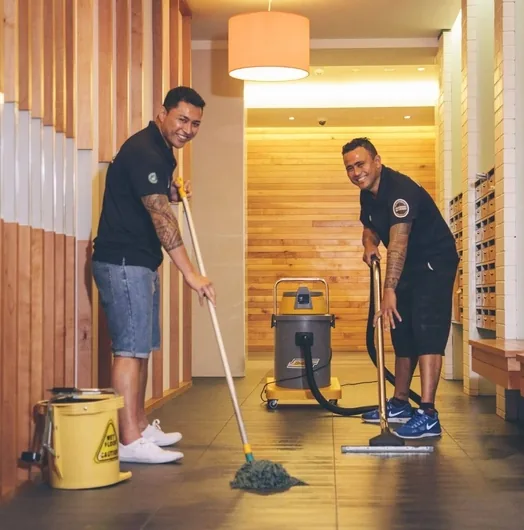 A CMOS cleaner in uniform being supervised during a quality check at a client site